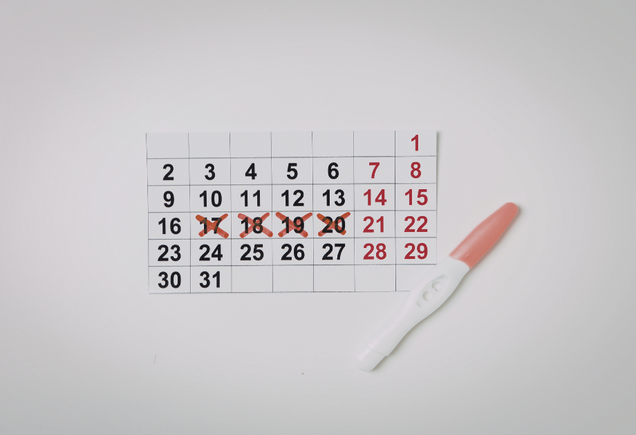 a 31 day calendar next to a pregnancy test